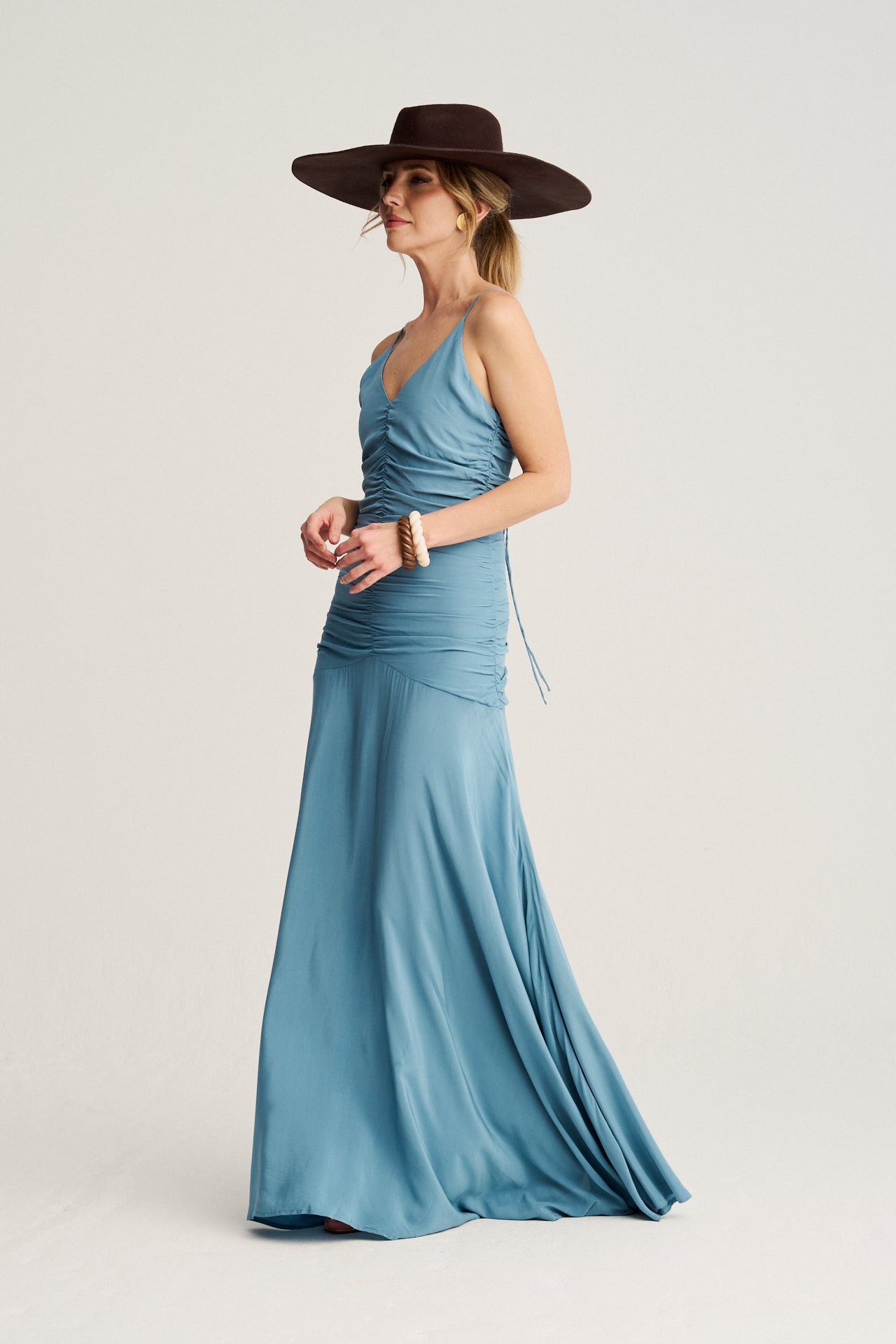 Vestido de gala azul con falda de mucho vuelo, frunces estilizados y tirantes versátiles para un look sofisticado.